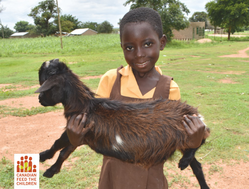 Buy a goat and receive this free card showing a smiling African girl holding a goat